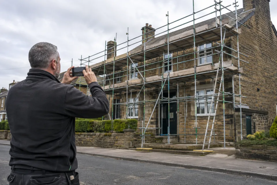 Supervisor capturing scaffold handover evidence on site